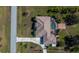 Overhead view of a house with a screened-in pool, landscaped yard, and mature trees at 2002 Palm View Rd, Sarasota, FL 34240