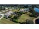 Residential neighborhood with mature trees and green spaces along a lake at 2002 Palm View Rd, Sarasota, FL 34240