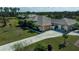 A sprawling single-story home, featuring a large yard, mature trees and a long driveway at 2002 Palm View Rd, Sarasota, FL 34240