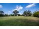Expansive green lawn with mature trees and landscaping, a peaceful outdoor setting at 2002 Palm View Rd, Sarasota, FL 34240
