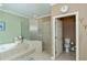 Another view of the bathroom showcasing soaking tub, tiled shower, and private toilet area at 2002 Palm View Rd, Sarasota, FL 34240