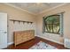 Cozy bedroom featuring hardwood floors, dresser, and bright window at 2002 Palm View Rd, Sarasota, FL 34240
