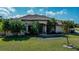 Attractive single story home featuring manicured landscaping, healthy green lawn and a covered front entryway at 2002 Palm View Rd, Sarasota, FL 34240