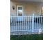 View of the front porch featuring a white fence and door with adjacent wall lighting at 2002 Palm View Rd, Sarasota, FL 34240