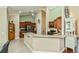 Open kitchen with granite counters, stainless appliances, and wood cabinets at 2002 Palm View Rd, Sarasota, FL 34240