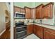 Gourmet kitchen with granite countertops, modern appliances, and rich wood cabinetry at 2002 Palm View Rd, Sarasota, FL 34240