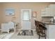 Bright kitchen features white cabinets, breakfast bar and adjacent desk space with a light-filled door at 2002 Palm View Rd, Sarasota, FL 34240