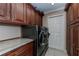 Well-organized laundry room with front load washer and dryer and granite countertops at 2002 Palm View Rd, Sarasota, FL 34240