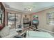 Comfortable living room with bright interior and large sliding glass doors to the patio and pool at 2002 Palm View Rd, Sarasota, FL 34240