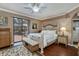 Comfortable main bedroom featuring wood floors, a ceiling fan, and a private patio at 2002 Palm View Rd, Sarasota, FL 34240