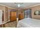 Another view of the main bedroom showcasing a large window with pool view and ceiling fan at 2002 Palm View Rd, Sarasota, FL 34240