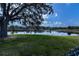 Scenic pond view surrounded by lush greenery and mature trees at 2002 Palm View Rd, Sarasota, FL 34240