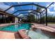 Screened pool area featuring a sparkling pool with a fountain and covered lounge area at 2002 Palm View Rd, Sarasota, FL 34240