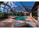 Relaxing screened-in pool area with lounge chairs, providing shade and comfort at 2002 Palm View Rd, Sarasota, FL 34240