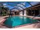Inviting screened-in pool with brick trim, and outdoor dining set, perfect for entertaining at 2002 Palm View Rd, Sarasota, FL 34240