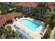 Aerial view of the community pool with palm trees and lounge chairs at 210 3Rd W St # 8204, Bradenton, FL 34205