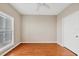 Clean bedroom with ceiling fan, hardwood floors, and bright natural light at 210 3Rd W St # 8204, Bradenton, FL 34205