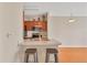 Efficient kitchen space featuring a breakfast bar with seating, stainless steel sink, and microwave at 210 3Rd W St # 8204, Bradenton, FL 34205