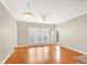 Spacious living room with hardwood flooring, ceiling fan, and access to the outdoor balcony at 210 3Rd W St # 8204, Bradenton, FL 34205