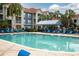 Inviting community pool with lounge chairs, palm trees, and covered seating area at 210 3Rd W St # 8204, Bradenton, FL 34205