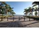 Scenic waterfront walkway lined with palm trees and banners with bridge view at 210 3Rd W St # 8204, Bradenton, FL 34205