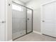 Modern shower with glass doors, gray tile, and hexagon floor tiles at 2157 Snug St, North Port, FL 34286