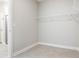 Spacious walk-in closet with wire shelving, tile floors, and easy access to bathroom at 2157 Snug St, North Port, FL 34286