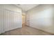 Bedroom with neutral colored walls, bi-fold closet doors and light tile flooring at 217 Potenza Loop, North Venice, FL 34275