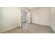 Clean, neutral bedroom with tile floors, and two entry doors at 217 Potenza Loop, North Venice, FL 34275