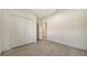 A bedroom with tile flooring, light-colored walls, and a closet for storage at 217 Potenza Loop, North Venice, FL 34275