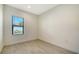 Bright bedroom features tile flooring and a window that lets in natural light at 217 Potenza Loop, North Venice, FL 34275