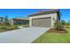 Lovely single-story home boasts a tile roof, manicured landscaping, and a two-car garage at 217 Potenza Loop, North Venice, FL 34275