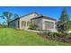 Attractive single-story home features a tile roof, stucco siding, landscaping, and a green lawn at 217 Potenza Loop, North Venice, FL 34275