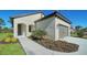 Well-maintained single story home with a tile roof, arched entryway, and attractive landscaping at 217 Potenza Loop, North Venice, FL 34275