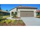 Charming single-story home with a tile roof, stucco exterior, and a well-manicured lawn at 217 Potenza Loop, North Venice, FL 34275