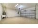 Spacious garage featuring a clean epoxy floor and ample room for parking and storage at 217 Potenza Loop, North Venice, FL 34275