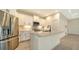 Beautiful kitchen with stainless steel refrigerator, white cabinets, and center island at 217 Potenza Loop, North Venice, FL 34275