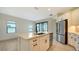 Kitchen view showing island with sink, stainless steel appliances and sliding glass doors at 217 Potenza Loop, North Venice, FL 34275
