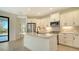 Bright kitchen with stainless steel appliances, white cabinetry, and a view of the outdoors at 217 Potenza Loop, North Venice, FL 34275