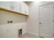 A utility sink and connections define the laundry room with overhead storage at 217 Potenza Loop, North Venice, FL 34275