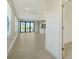 Bright, airy living room with tile floors, large windows, and sliding doors to the outside at 217 Potenza Loop, North Venice, FL 34275