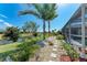 Beautiful backyard with lush landscaping, a charming stone walkway, and a tranquil canal view at 221 Fairway Rd, Rotonda West, FL 33947