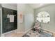 Bathroom featuring a patterned rug, patterned chair and a window featuring an arched top at 221 Fairway Rd, Rotonda West, FL 33947