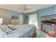 Well-lit bedroom featuring blue walls and white trim, complemented by wood-look flooring at 221 Fairway Rd, Rotonda West, FL 33947