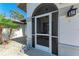 Welcoming screened front porch and a landscaped yard offer a pleasant entry to the home at 221 Fairway Rd, Rotonda West, FL 33947