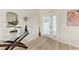 Bright foyer featuring light wood floors, glass table, decorative mirror, and a welcoming ambiance at 221 Fairway Rd, Rotonda West, FL 33947