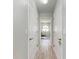 Hallway with linen closet leading to sitting area with a arched window at 221 Fairway Rd, Rotonda West, FL 33947