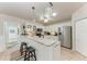 Bright kitchen features stainless steel appliances, granite countertops, and a breakfast bar with seating at 221 Fairway Rd, Rotonda West, FL 33947