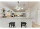 Bright kitchen features stainless steel appliances, granite countertops, and a breakfast bar with seating at 221 Fairway Rd, Rotonda West, FL 33947