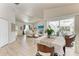Open-concept living area features wood-look floors and flows seamlessly to an outdoor space at 221 Fairway Rd, Rotonda West, FL 33947